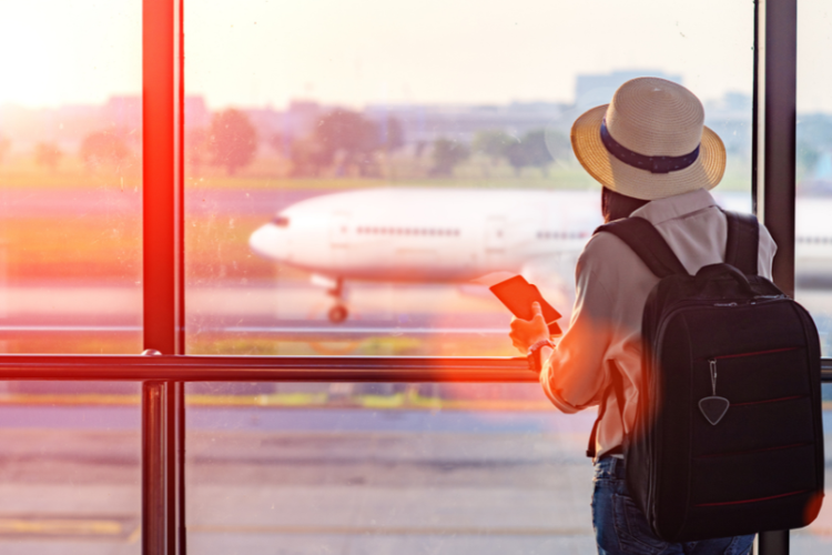 Someone waiting in the airport looking at the plane